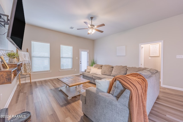 living room featuring hardwood / wood-style floors and ceiling fan