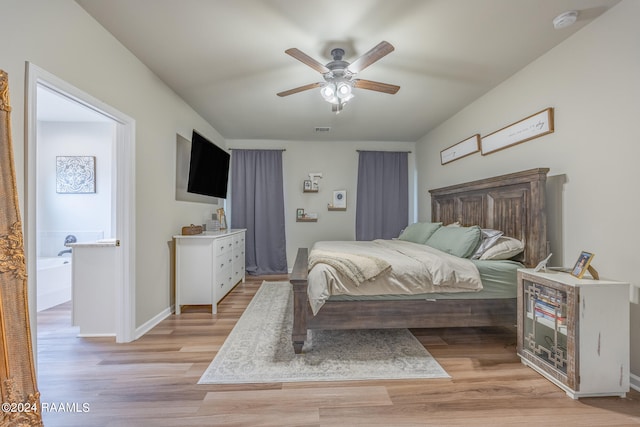 bedroom with light hardwood / wood-style floors, ceiling fan, and ensuite bathroom