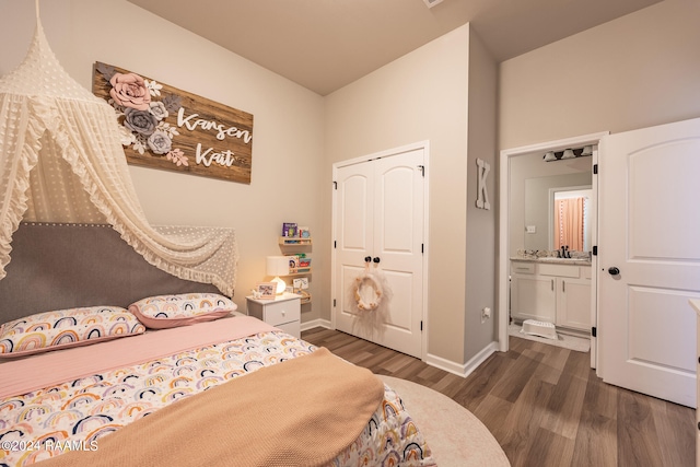 bedroom featuring dark hardwood / wood-style flooring, a closet, and sink