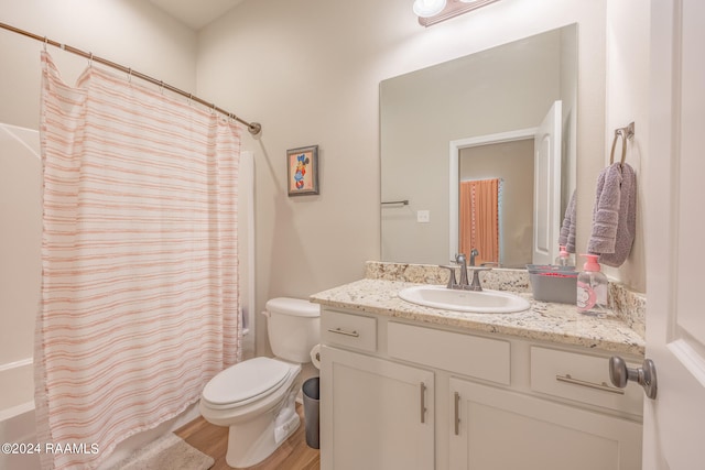 full bathroom featuring toilet, shower / bath combination with curtain, vanity, and hardwood / wood-style floors