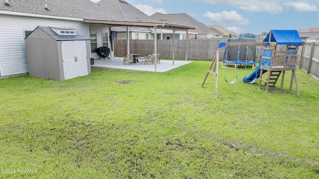 view of yard featuring a patio, a trampoline, and a storage shed