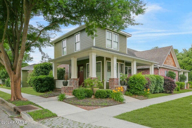 view of front of house with a front lawn and a porch