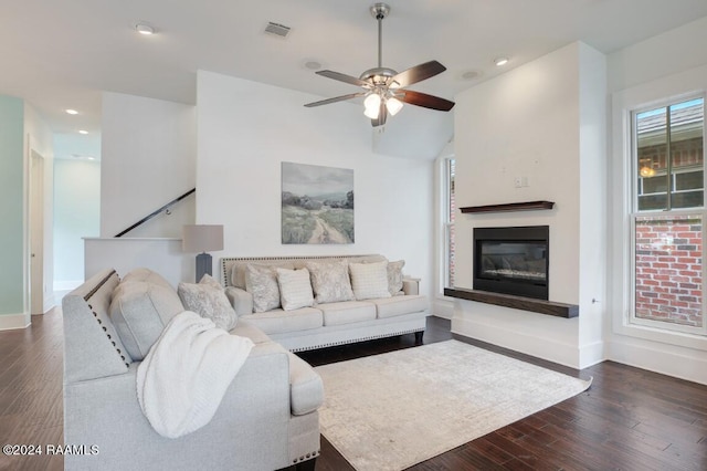 living room featuring ceiling fan and dark hardwood / wood-style floors