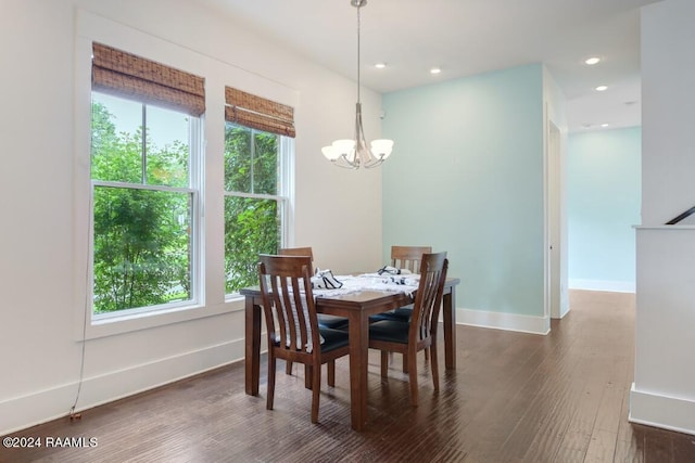 dining space featuring dark hardwood / wood-style floors and a notable chandelier