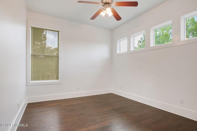 empty room featuring ceiling fan and dark wood-type flooring