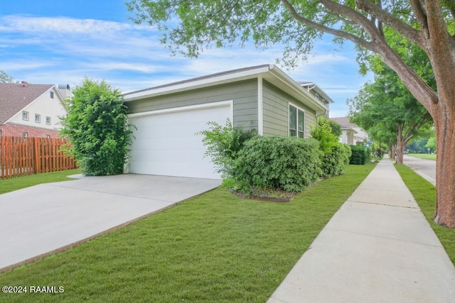 view of home's exterior with a garage and a yard