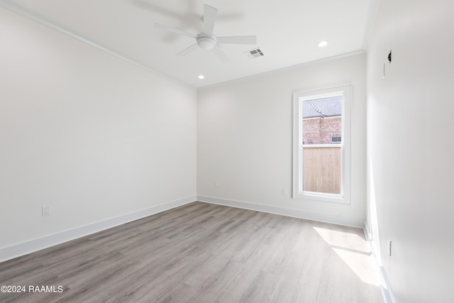 unfurnished room featuring ceiling fan, light wood-type flooring, and ornamental molding