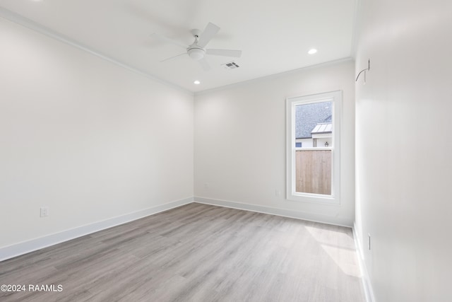 empty room featuring light hardwood / wood-style floors, ceiling fan, and crown molding