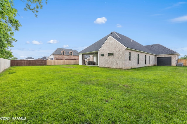 back of house with a lawn