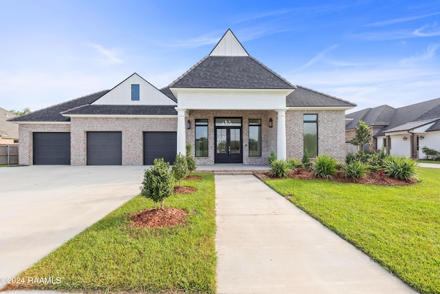 view of front of house featuring french doors, concrete driveway, a garage, a shingled roof, and a front yard