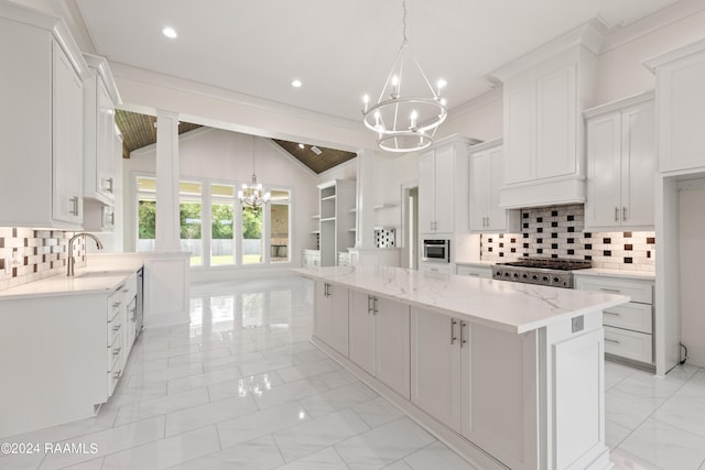 kitchen with lofted ceiling, a kitchen island, and white cabinets