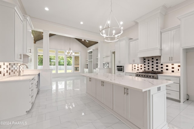 kitchen with marble finish floor, a large island, vaulted ceiling, a sink, and a chandelier
