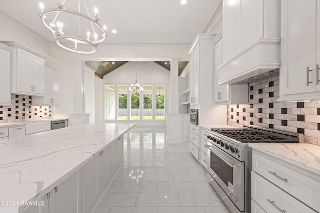 kitchen featuring stainless steel stove, a chandelier, marble finish floor, white cabinetry, and ornate columns