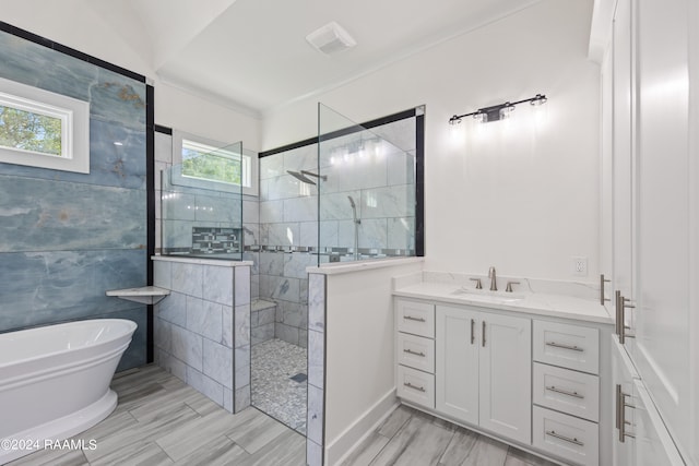 bathroom featuring vanity and shower with separate bathtub