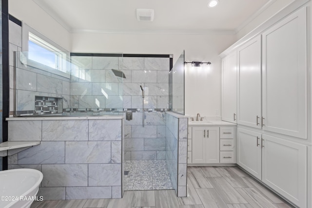 bathroom with recessed lighting, walk in shower, a freestanding tub, crown molding, and vanity