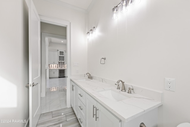 bathroom with vanity and ornamental molding