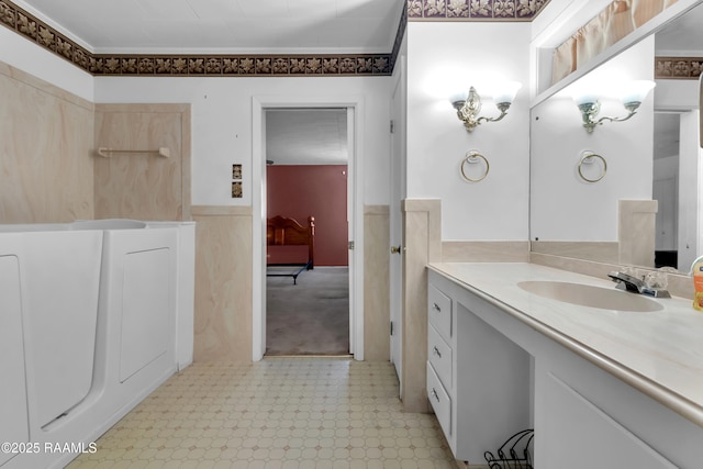 617 Cemetery Rd, Saint Martinville, LA 70582 - bathroom with vanity, a wainscoted wall, tile patterned floors, crown molding, and washer / clothes dryer
