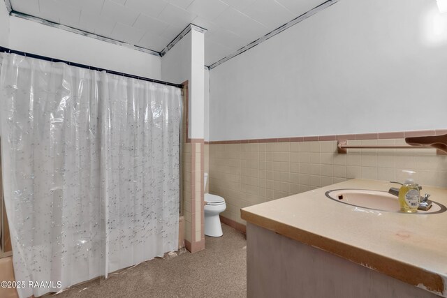617 Cemetery Rd, Saint Martinville, LA 70582 - bathroom with toilet, tile walls, vanity, a wainscoted wall, and a shower with shower curtain