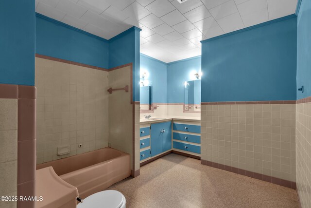617 Cemetery Rd, Saint Martinville, LA 70582 - full bath featuring tile walls, wainscoting, vanity, and toilet
