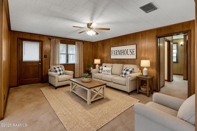 617 Cemetery Rd, Saint Martinville, LA 70582 - living area featuring light carpet, ceiling fan, and wooden walls