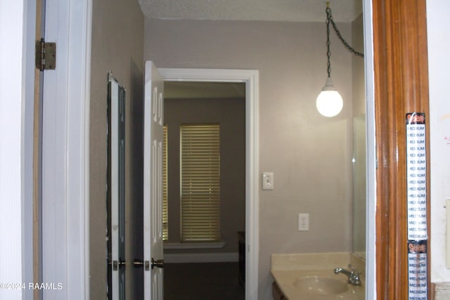 bathroom with vanity and a textured ceiling