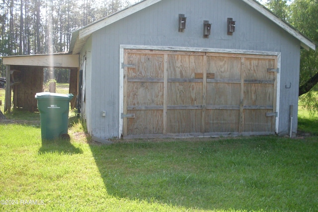 garage featuring a lawn