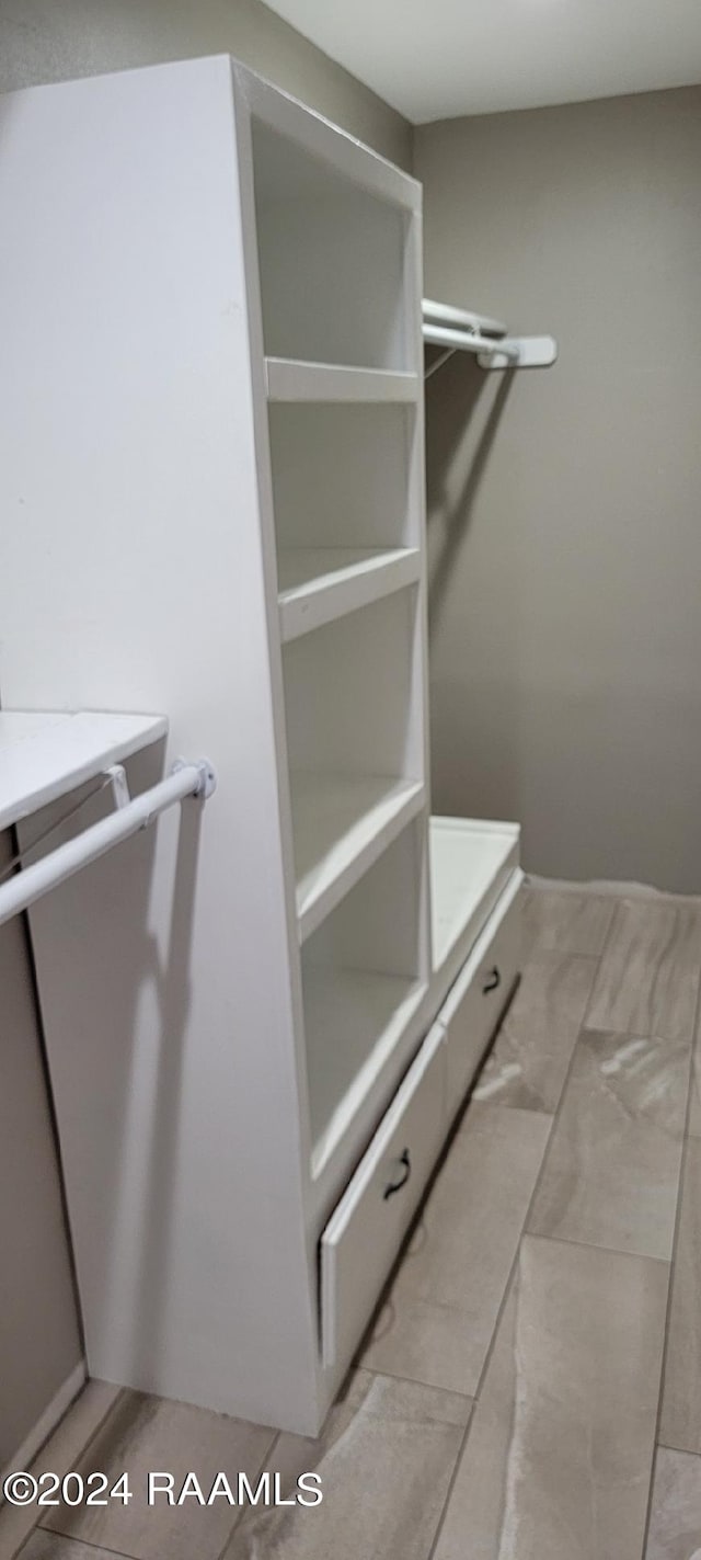 spacious closet featuring light tile floors