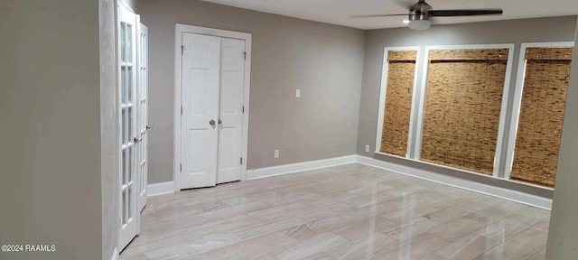 unfurnished bedroom featuring two closets and ceiling fan