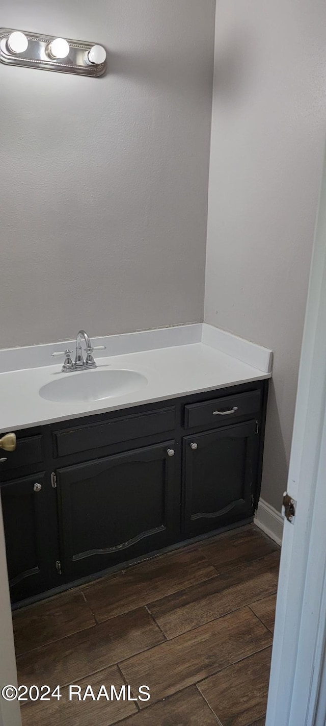 bathroom with hardwood / wood-style floors and vanity