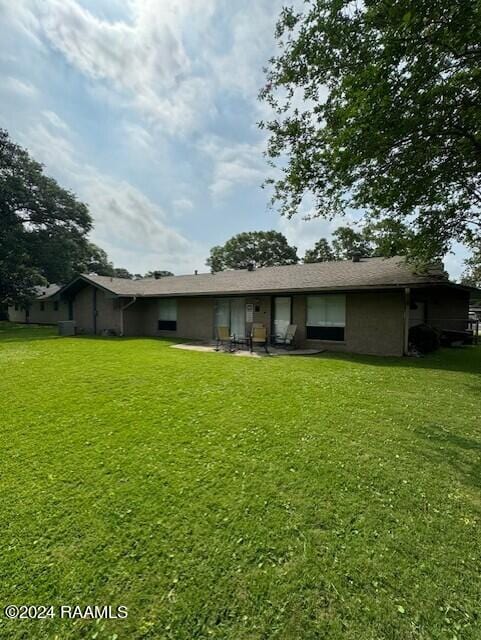 rear view of house with a lawn