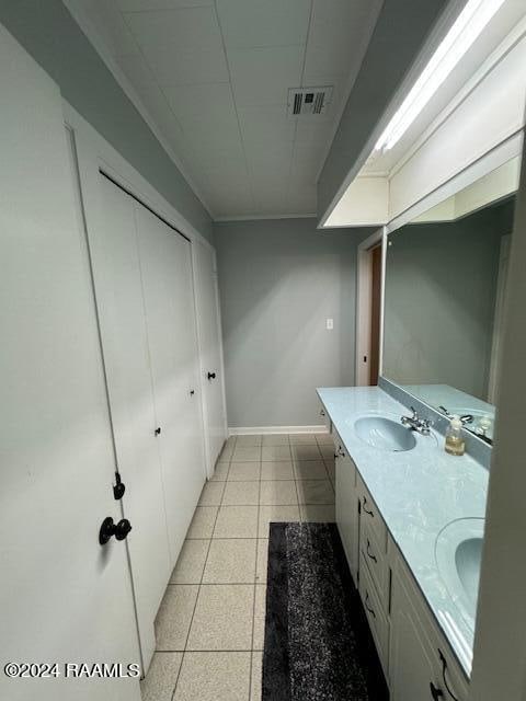 bathroom with tile patterned flooring and vanity