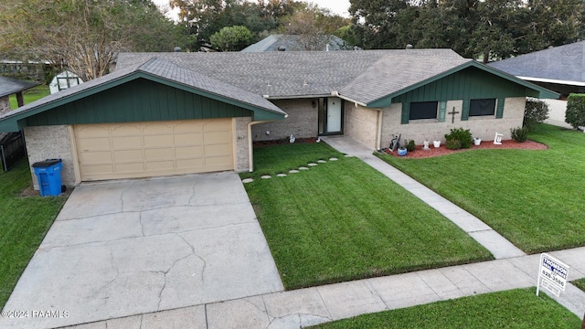 ranch-style home featuring a front lawn and a garage