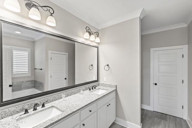 bathroom with crown molding, a tub, and dual vanity