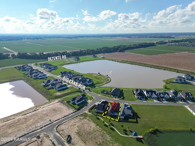 drone / aerial view with a rural view and a water view