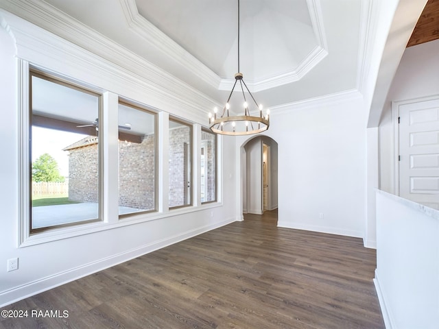 unfurnished dining area with a raised ceiling, crown molding, and dark wood-type flooring