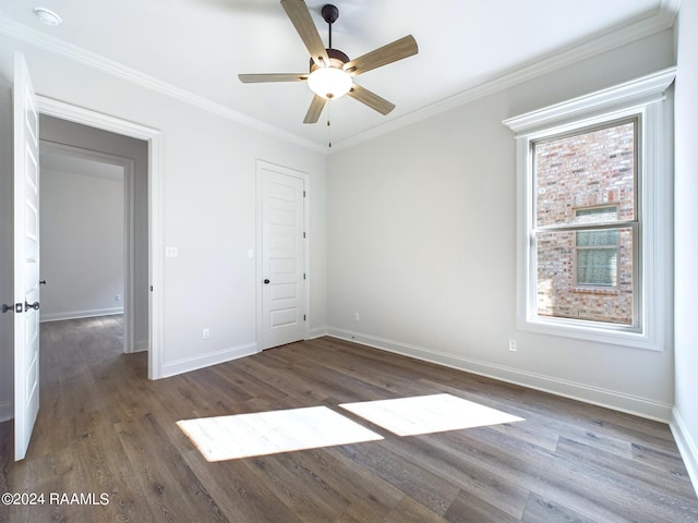 unfurnished bedroom featuring a closet, ceiling fan, dark hardwood / wood-style flooring, and ornamental molding