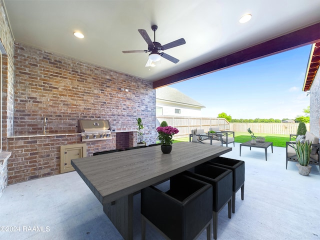 view of patio / terrace with ceiling fan, a grill, an outdoor hangout area, and exterior kitchen