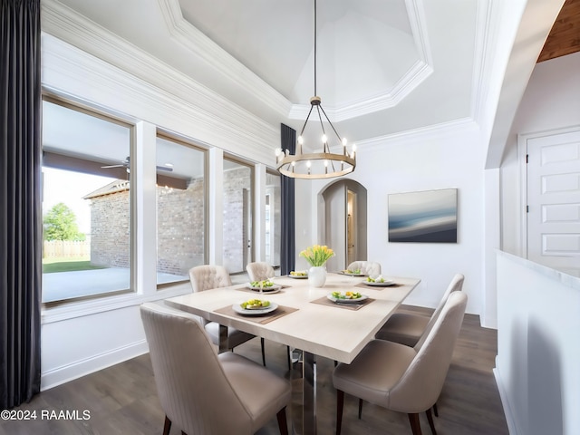 dining area featuring a tray ceiling, crown molding, dark hardwood / wood-style floors, and an inviting chandelier