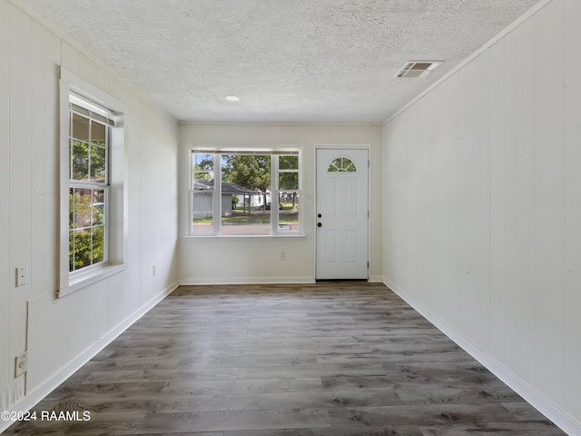 interior space featuring a textured ceiling and wood-type flooring