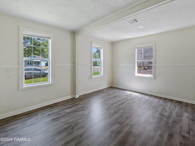 empty room featuring a textured ceiling and dark hardwood / wood-style floors