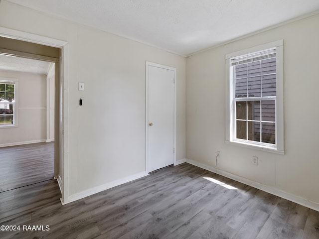 unfurnished room featuring a textured ceiling and hardwood / wood-style floors