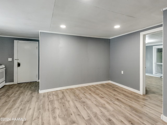 spare room with light hardwood / wood-style floors and ornamental molding