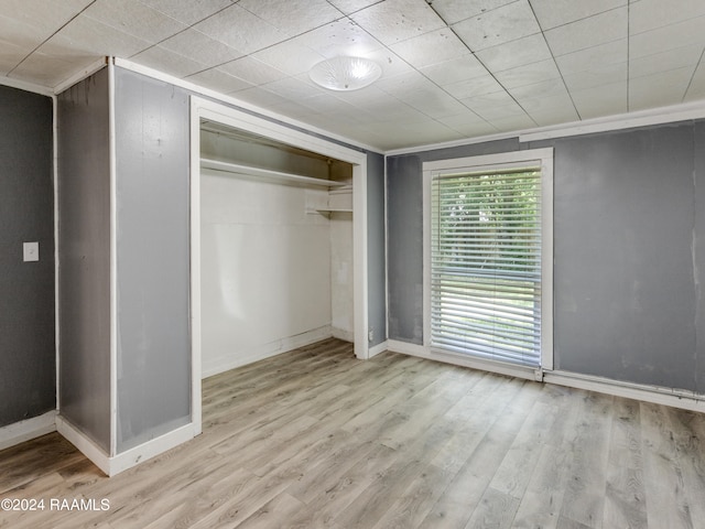 unfurnished bedroom featuring a closet and light hardwood / wood-style floors