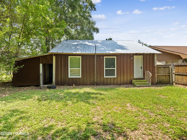 back of house with a yard