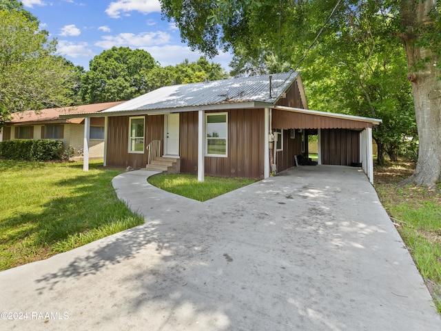 ranch-style house with a carport and a front lawn