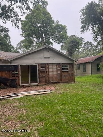 rear view of property with a lawn