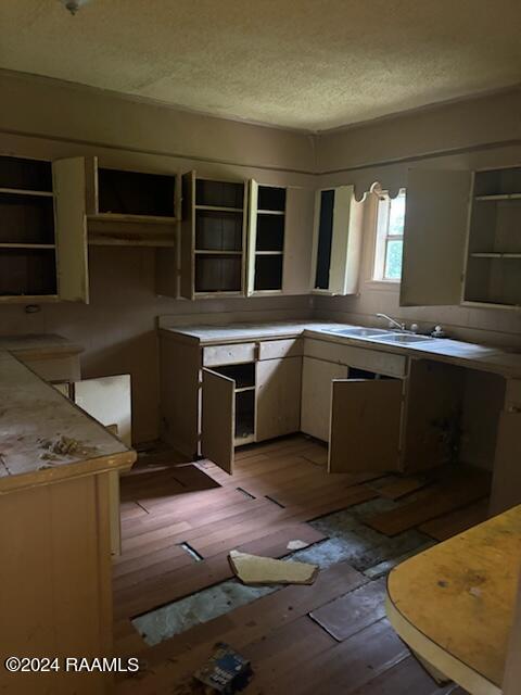 kitchen with light hardwood / wood-style floors and a textured ceiling