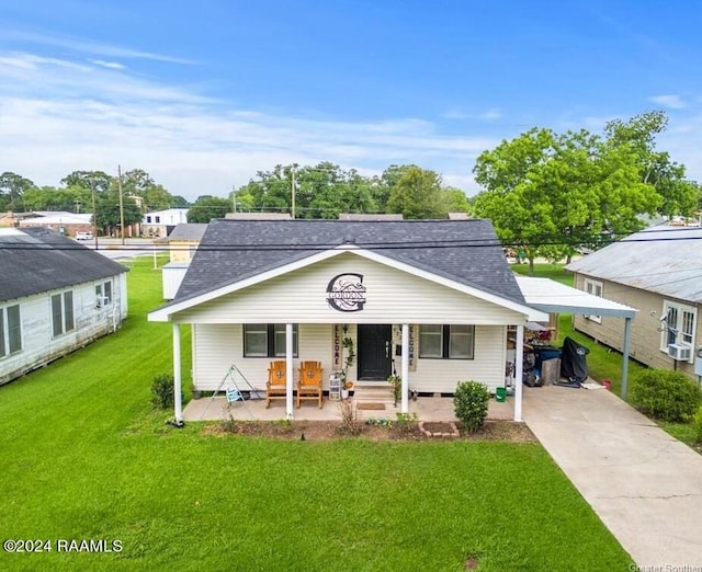 view of front of home featuring a carport, a front yard, and a porch