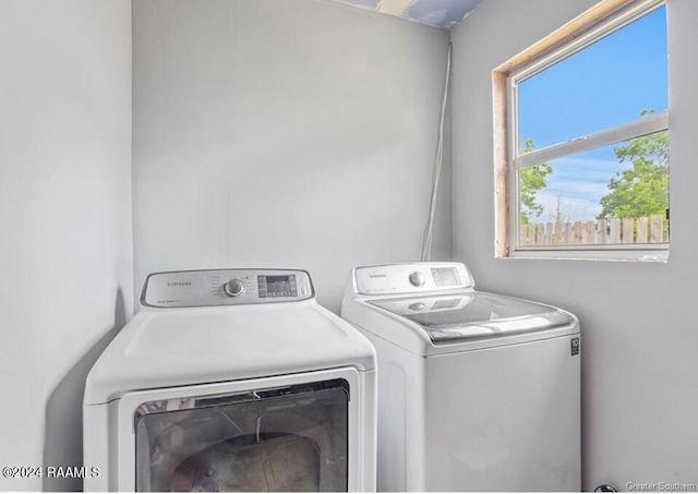 clothes washing area featuring independent washer and dryer