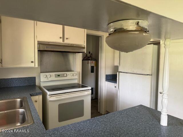 123 Lester St, Ville Platte, LA 70586 - kitchen with sink, electric water heater, white appliances, and white cabinetry